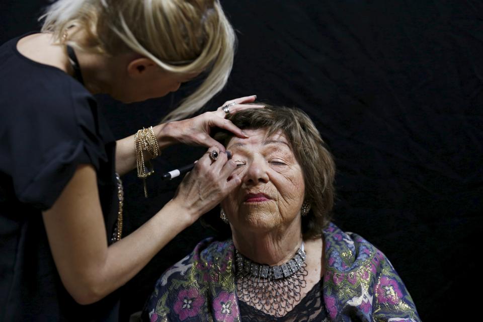 Stela Krashes, a Holocaust survivor, has her make-up done during preparations ahead of a beauty contest for survivors of the Nazi genocide in Haifa