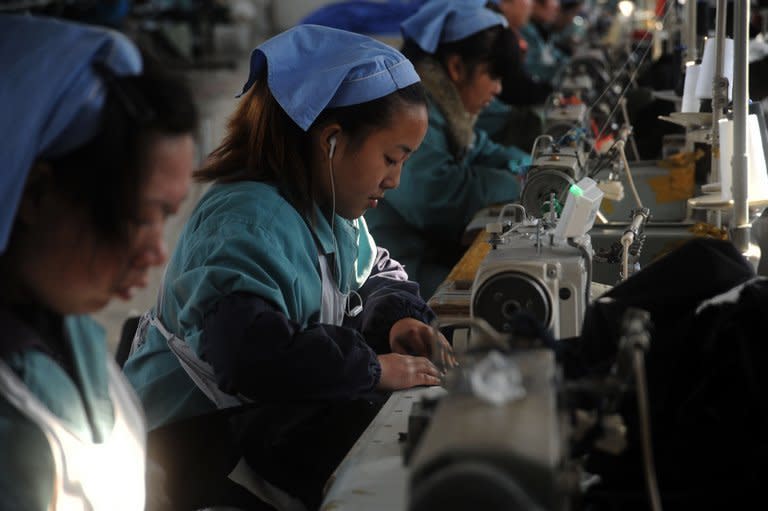 Laborers work in a clothing factory in Huaibei, central China's Anhui province, on January 10, 2013. Foreign direct investment in China declined for the first time in three years in 2012, official data shows, amid economic turmoil in developed markets and a slowdown at home