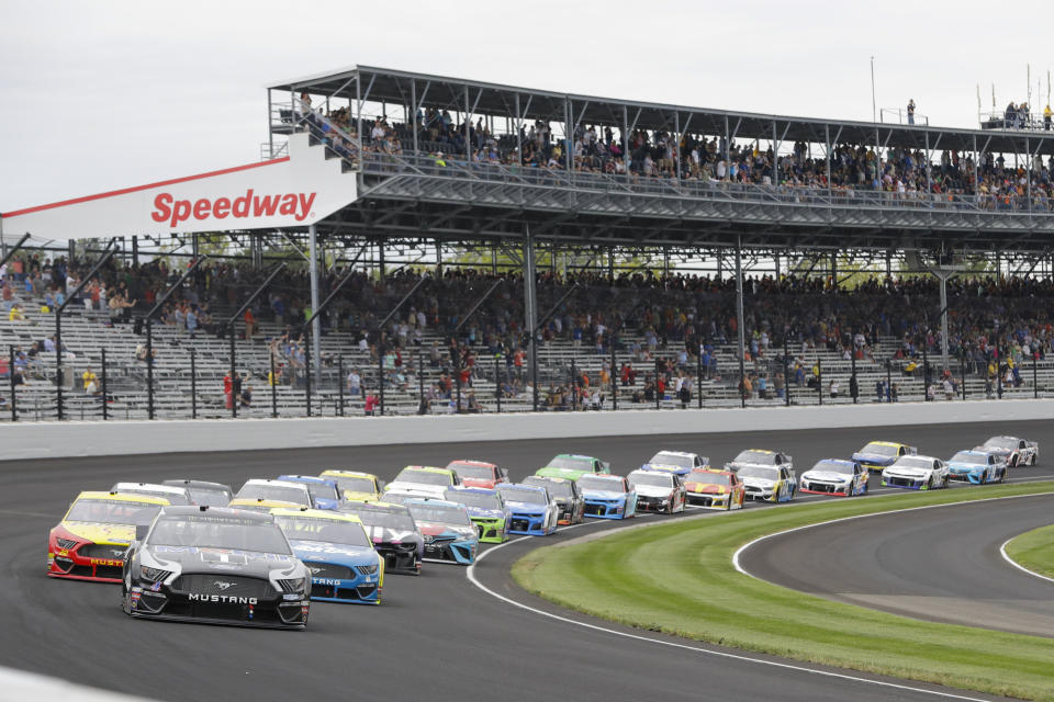 Kevin Harvick leads the field through the first turn on the start of the NASCAR Brickyard 400 auto race at Indianapolis Motor Speedway, Sunday, Sept. 8, 2019, in Indianapolis. (AP Photo/Darron Cummings)