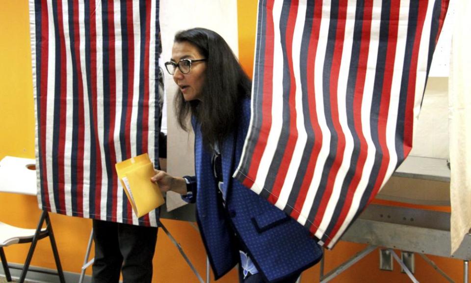 Mary Peltola is shown leaving a voting booth during early voting in Anchorage, Alaska.