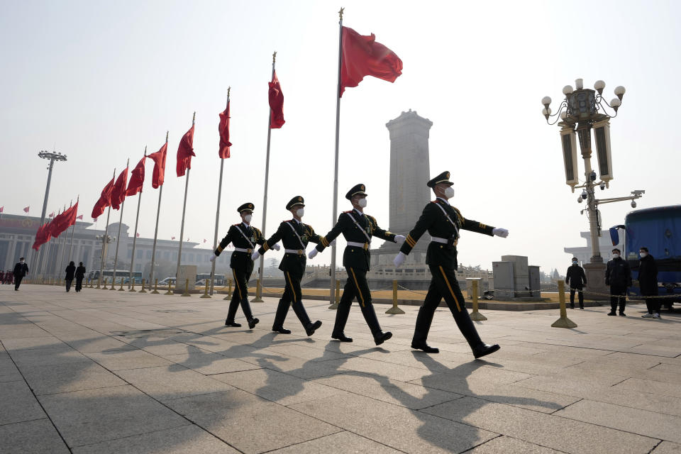 Chinese paramilitary policemen march across Tiananmen Square near the Great Hall of the People where the annual Congress will be held in Beijing, Saturday, March 4, 2023. Increases in China's defense budget have been "appropriate and reasonable" and are aimed at meeting "complex security challenges," a spokesperson for the country's rubber-stamp parliament said Saturday. (AP Photo/Ng Han Guan)