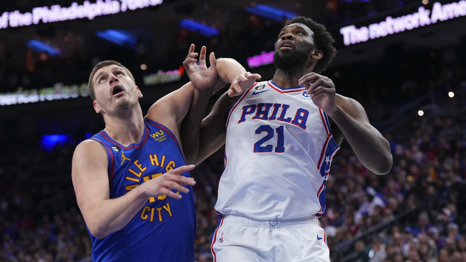 Denver's Nikola Jokic battles with Philadelphia's Joel Embiid during a January game in Philadelphia on the court, and off the court as the MVP debate rises. (Mitchell Leff/Getty Images)