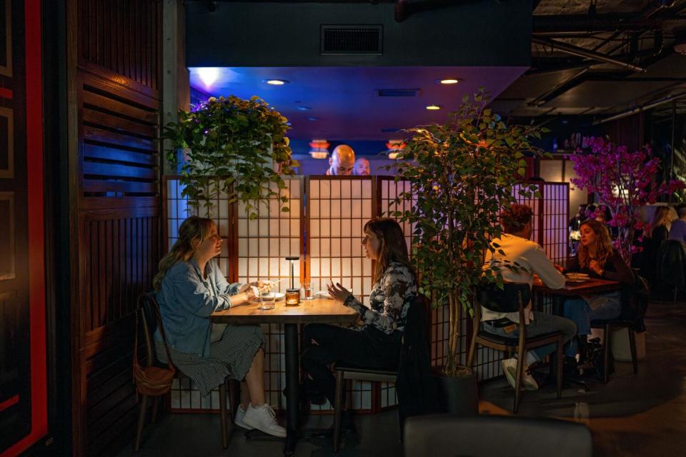 People dine in the glowing atmosphere of Budonoki.