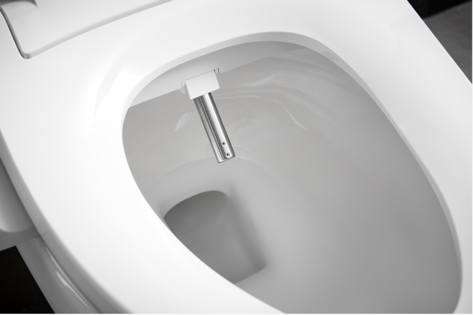 Water squirts out of a small spout in bidet seats like this Kohler one.
