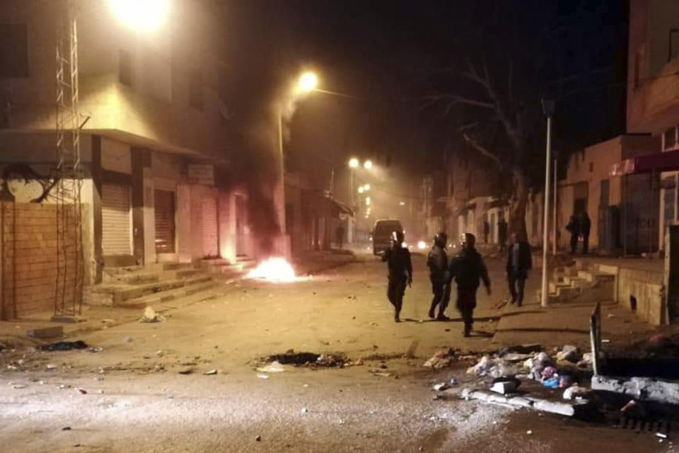 Tunisian Police officers patrol after clashes in the streets of Kasserine, southern of Tunisia, Tuesday, Dec 25, 2018.The death of a Tunisian journalist Abderrak Zorgui who set himself on fire to protest economic problems in the North African nation prompted a protest that led to clashes with police and nationwide concern. (AP Photo/Mohamed Ben Salah)