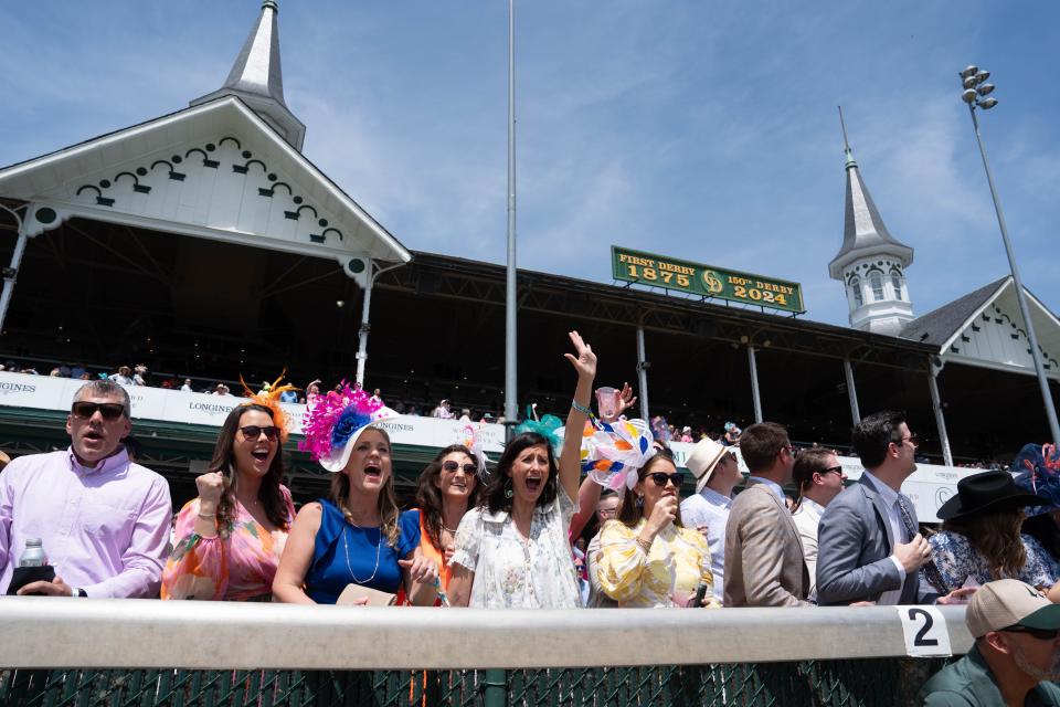 Fans cheer as the horses from the second race cross the finish line during Thurby at Churchill Downs on Thursday, May 2, 2024.