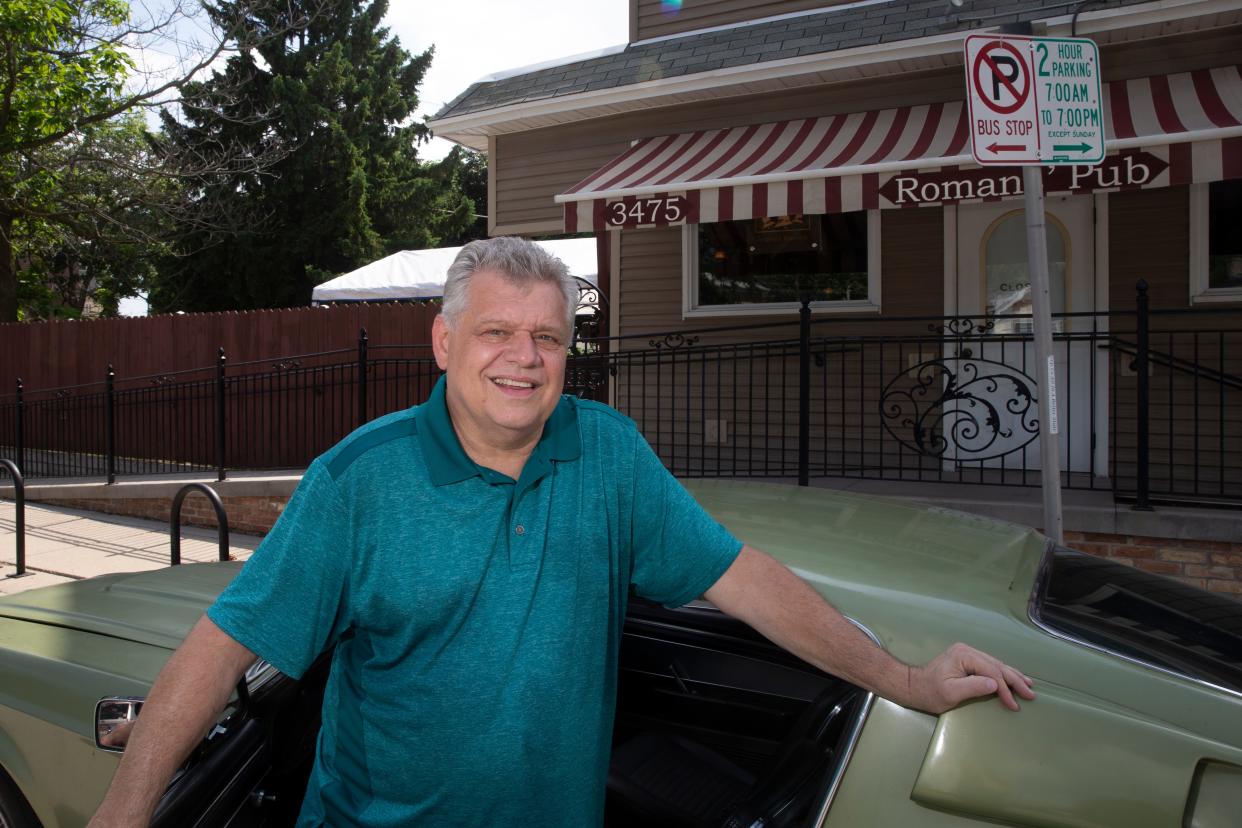 Mike Romans, owner of Romans' Pub, poses next to his 1967 Shelby GT350 outside his home and bar in Bay View. Romans died July 22 at age 69.