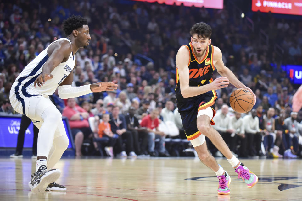 Oklahoma City Thunder forward Chet Holmgren, right, drives past Memphis Grizzlies forward Jaren Jackson Jr., left, in the first half of an NBA basketball game, Sunday, March. 10, 2024, in Oklahoma City. (AP Photo/Kyle Phillips)