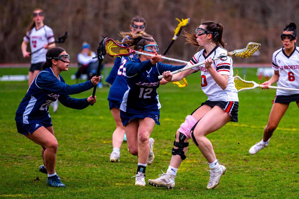 Old Rochester's Kelly Quinlan is covered tightly by Apponequet's Amelia Menendez and Cynthia Morales.