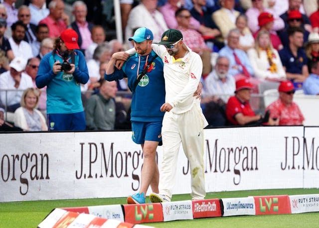 Nathan Lyon is helped from the field after picking up an injury 