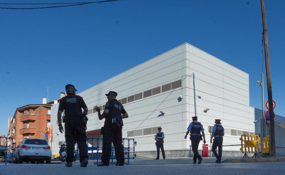 Police stand guard outside the police station on the outskirts of Barcelona (EPA)
