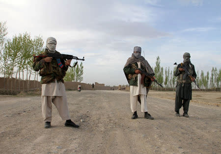 FILE PHOTO - Members of the Taliban stand at the site of the execution of three men in Ghazni province, Afghanistan, April 18, 2015. REUTERS/Stringer/File Photo