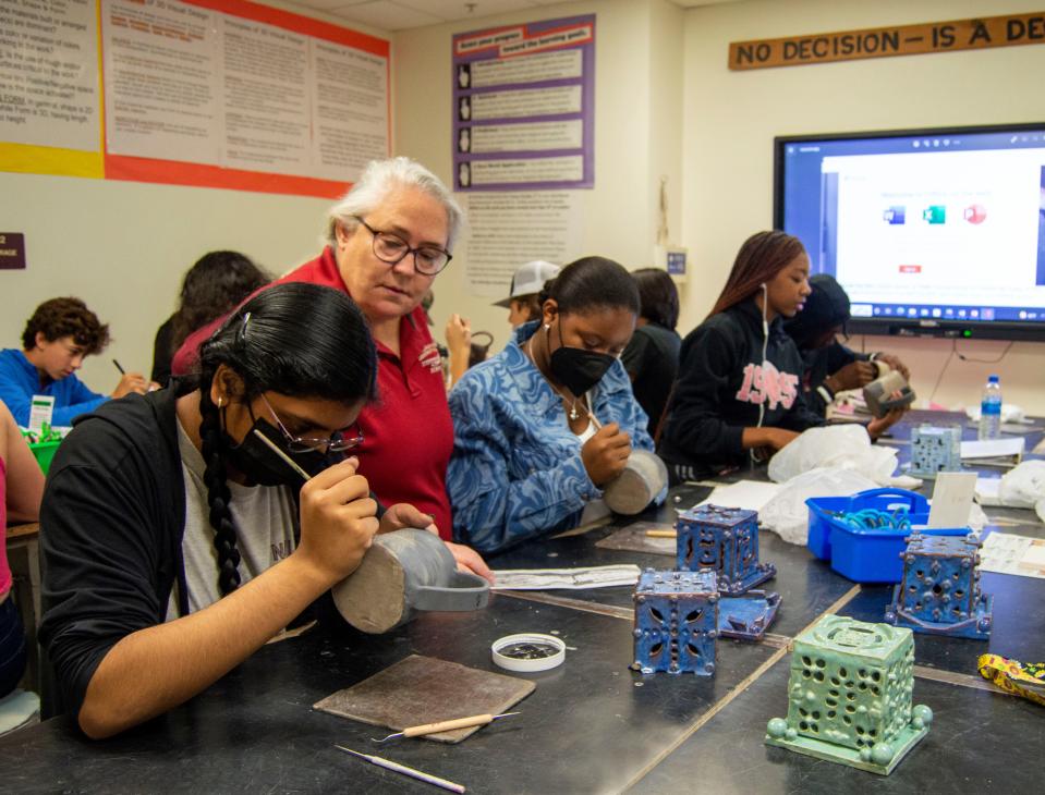 Leon County teacher Barbara Davis oversees work in a ceramics class.