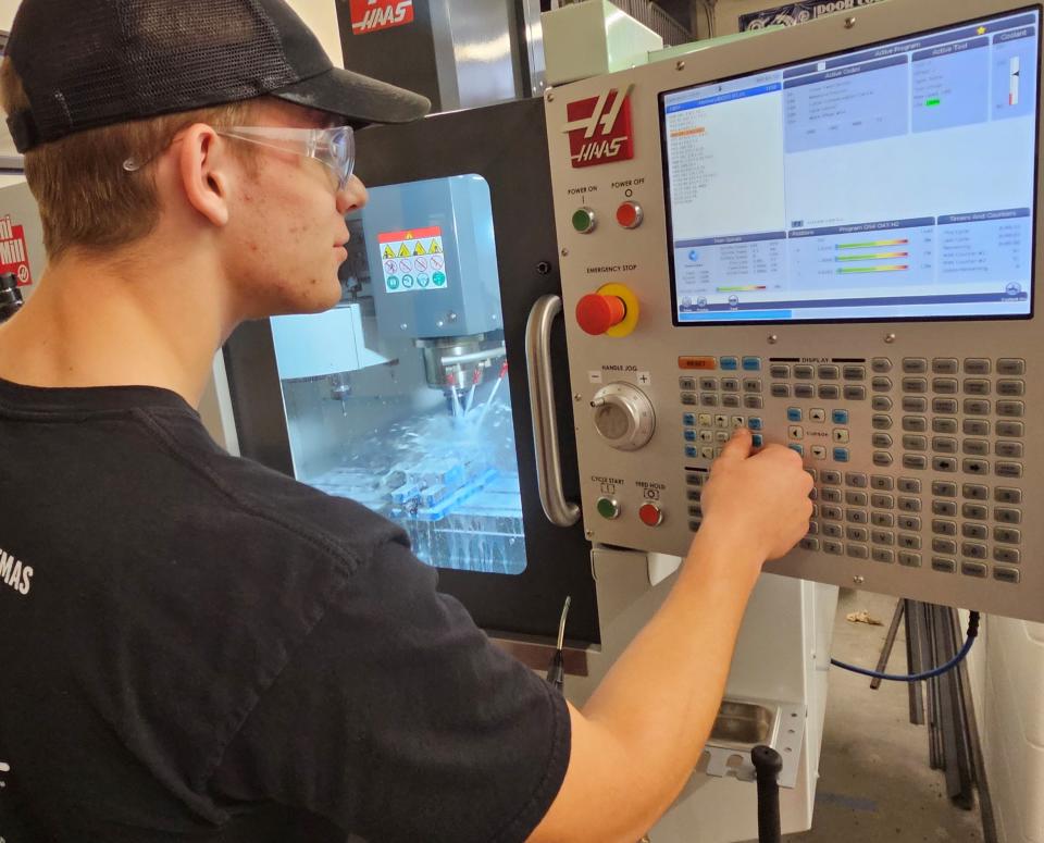 Sevastopol High School senior Alex Andreae operates a CNC (computer numerical control) machine to cut precise slots into a metal block in a class for the Door County Machining Program at Sevastopol School.