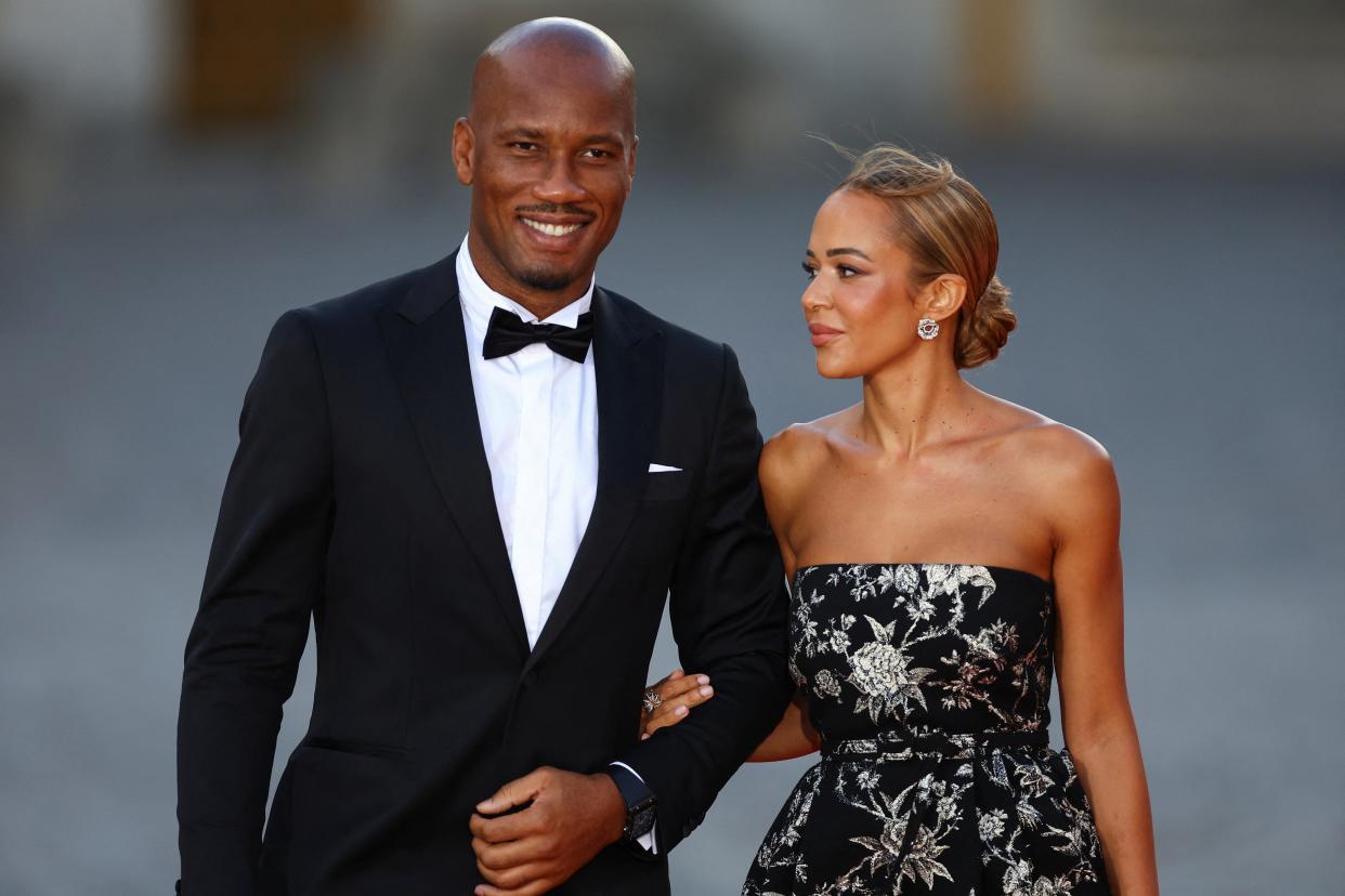 Didier Drogba and Gabrielle Lemaire arrive to attend a state dinner in honor of Britain's King Charles and Queen Camilla (REUTERS)