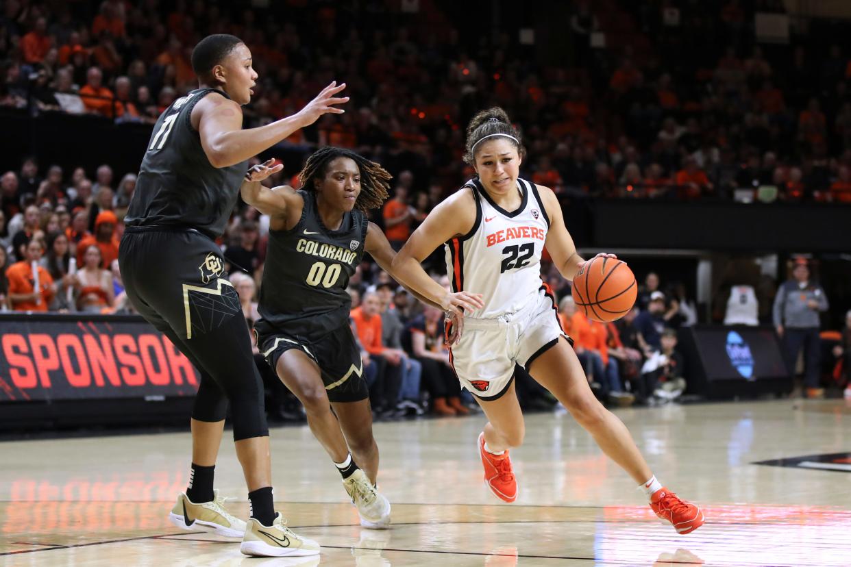 Oregon State guard Talia von Oelhoffen (22) dribbles the ball past Colorado forward Quay Miller (11) and guard Jaylyn Sherrod (0) during the first half of the game Friday, Jan. 26, 2024, in Corvallis, Ore.