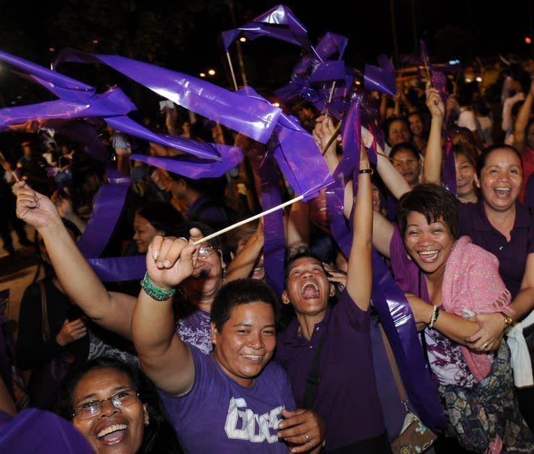 People celebrate after legislators pass a landmark birth control bill in Manila on December 17, 2012. Philippine Catholic leaders have vowed to overturn a birth control bill after lawmakers passed landmark legislation to make sex education and contraceptives more widely available