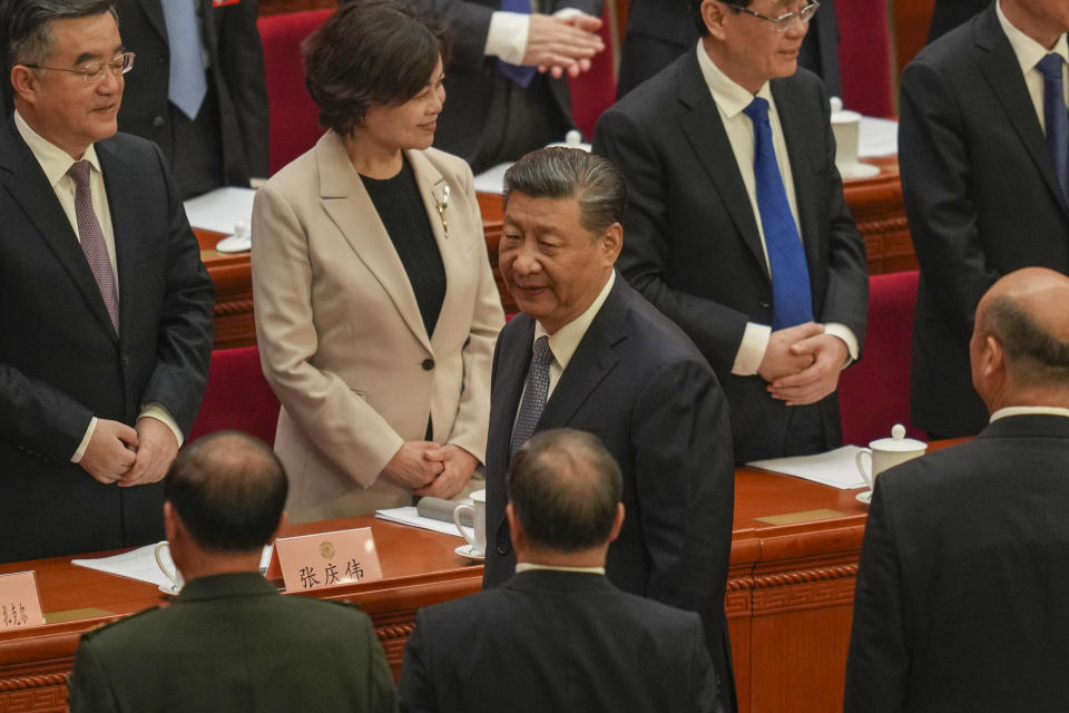 Chinese President Xi Jinping, center, leaves after the opening session of the Chinese People's Political Consultative Conference in the Great Hall of the People in Beijing, Monday, March 4, 2024. (AP Photo/Tatan Syuflana)