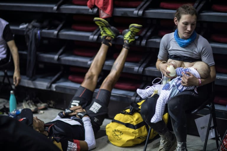 Great-Britain's trail runner Sophie Power breastfeeds her three months old baby Cormac