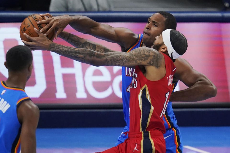 New Orleans Pelicans forward Brandon Ingram, front right, drives past Oklahoma City Thunder's Al Horford, rear right, in the first half of an NBA basketball game Thursday, Dec. 31, 2020, in Oklahoma City. (AP Photo/Sue Ogrocki)