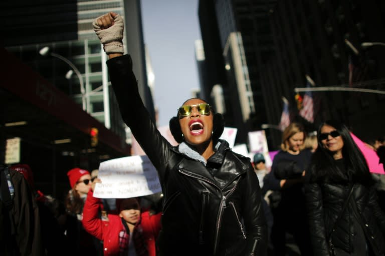 A woman protests in New York City where hundreds of thousands marched in protest of Donald Trump, one year after his inauguration