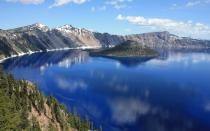 <p>Deep, impossibly dark blue waters have collected in the crater of an active volcano from pure rainfall and snowmelt over thousands of years. Today, Crater Lake National Park boasts, at 1,943 feet, the deepest and cleanest lake in the country, as there are no inlets or outlets to allow for contamination. The best views of the lake can be accessed from vistas along East and West Rim Drive, as well as from points that can be reached during one of many day hikes. The solitude of this park in the wintertime is like no other, and cross-country skiers and snowshoers should not miss an opportunity to experience it.</p>