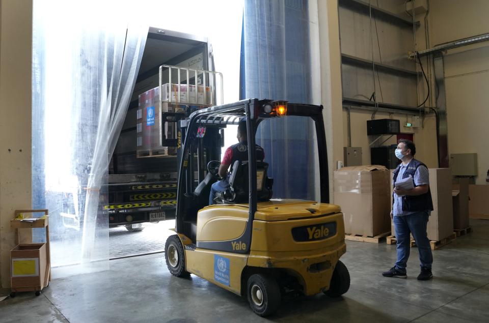A forklift driver loads healthcare material to be sent to Afghanistan, at a UNHCR warehouse, part of the International Humanitarian City in Dubai, United Arab Emirates, Monday, June 27, 2022. (AP Photo/Kamran Jebreili)