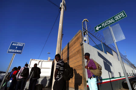 Haitian migrants wait outside the Migrant Care office after leaving Brazil, where they sought refuge after Haiti's 2010 earthquake, but are now attempting to enter the U.S., in Tijuana, Mexico, October 3, 2016. Picture taken October 3, 2016. REUTERS/Edgard Garrido