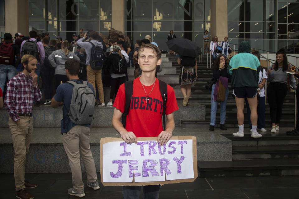 Garreidy Hamilton, a freshmen in governments and policy, holds a sign reading "I trust Jerry" during a student protest on Friday, Sept. 13, 2019, at Liberty University in Lynchburg, Va. Students at Liberty University gathered to protest in the wake of news articles alleging that school president Jerry Falwell Jr. "presides over a culture of self-dealing” and improperly benefited from the institution. Falwell Jr. told The Associated Press on Tuesday that he wants the FBI to investigate what he called a "criminal" smear campaign orchestrated against him by several disgruntled former board members and employees.(Emily Elconin/The News & Advance via AP)