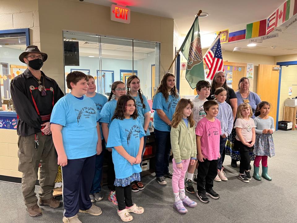 A collection of people witnessed the raising of the Missisquoi Abenaki flag at Gertrude Chamberlin School in South Burlington on Nov. 14, 2023. Pictured are good citizen students from the school, drummers from the Abenaki Circle of Courage program in Swanton (dressed in blue), Chief Brenda Gagne of the Abenaki Nation of Missisquoi (back, second from right) and a couple members of the tribe including Holly LaFrance (back right).