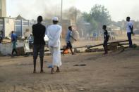 Locals set tyres on fire and block a sidestreet leading to their neighbourhood in the Sudanese capital Khartoum to stop military vehicles from driving through the area on June 4, 2019