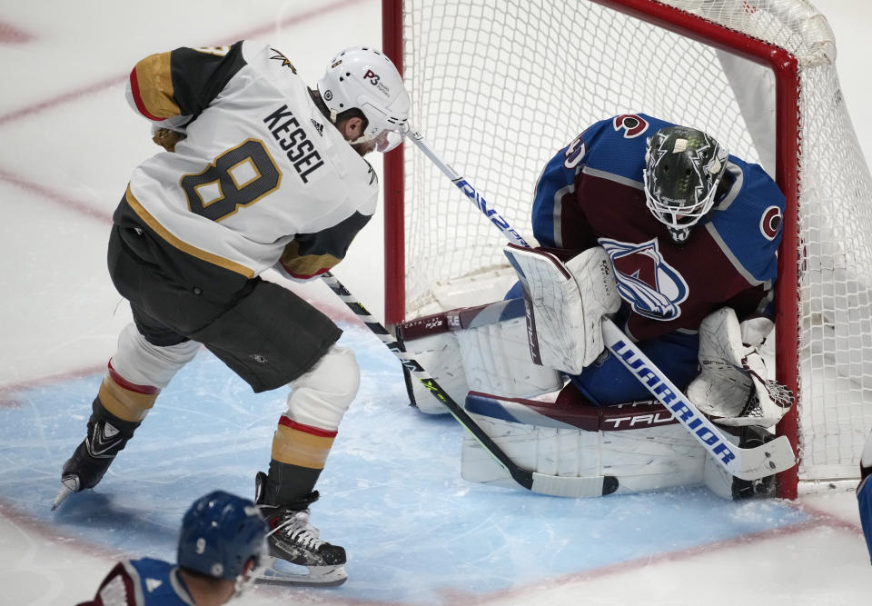 Colorado Avalanche goaltender Alexandar Georgiev, right, makes a stic-save against a shot by Vegas Golden Knights right wing Phil Kessel (8) in the first period of an NHL hockey game Monday, Feb. 27, 2023, in Denver. (AP Photo/David Zalubowski)
