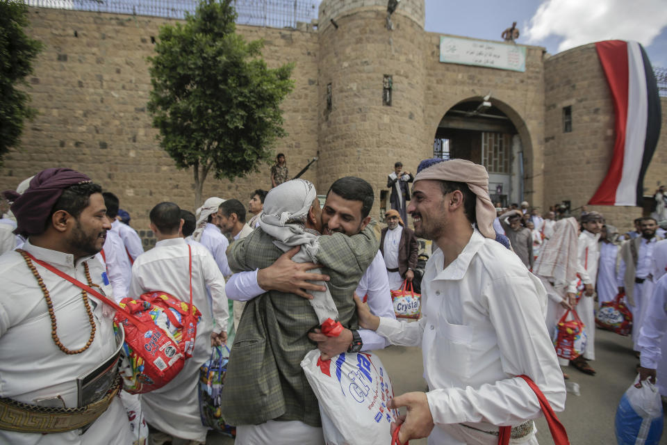 A Yemeni detainee is greeted by his relative after his release from a prison controlled by Houthi rebels, in Sanaa, Yemen, Monday, Sept. 30, 2019. The International Committee of the Red Cross says Yemen's Houthi rebels have released 290 detainees rounded up over the years and held in several detention centers across the war-torn country. (AP Photo/Hani Mohammed)