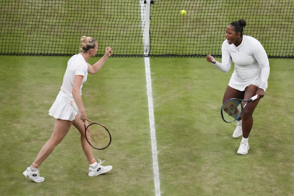 Katerina Siniakova, left, of Czech Republic and Taylor Townsend of the United States react after winning the first set against Gabriela Dabrowski of Canada and Erin Routliffe of New Zealand in the women's doubles finalat the Wimbledon tennis championships in London, Saturday, July 13, 2024. (AP Photo/Kirsty Wigglesworth)