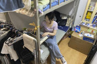 Recent college graduate Liu Qian works on her laptop computer in the room she rents in an apartment in Beijing, Thursday, July 7, 2022. Liu is one of 11 million new graduates desperate for work in a bleak job market as anti-virus controls force factories, restaurants and other employers to close. The survivors are cutting jobs and wages. (AP Photo/Olivia Zhang)