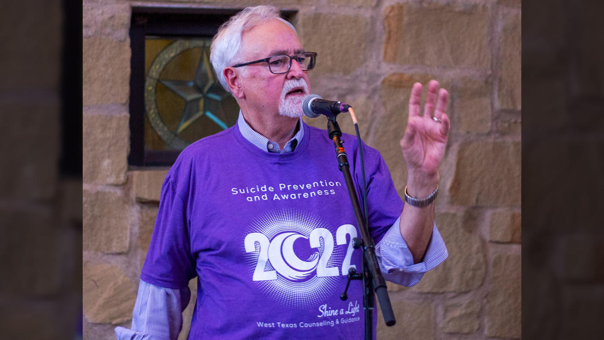 Dr. Frank Campbell speaking into a microphone.