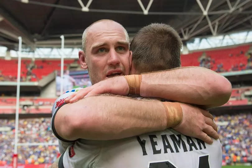 Gareth Ellis and Kirk Yeaman embrace at Wembley.