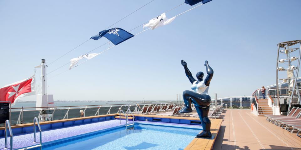 An outdoor pool with a statue on the MSC Meraviglia