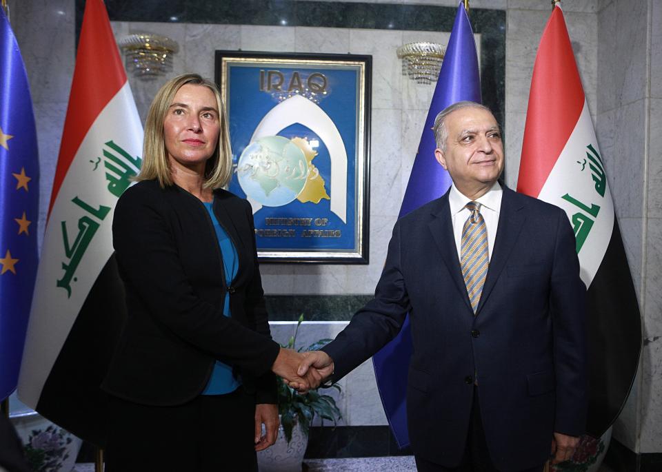 Iraqi Foreign Minister Mohamed Alhakim, right, shakes hands with visiting European Union foreign policy chief Federica Mogherini before their meeting at the Ministry of Foreign Affairs in Baghdad, Iraq, Saturday, July 13, 2019. (AP Photo/Hadi Mizban)