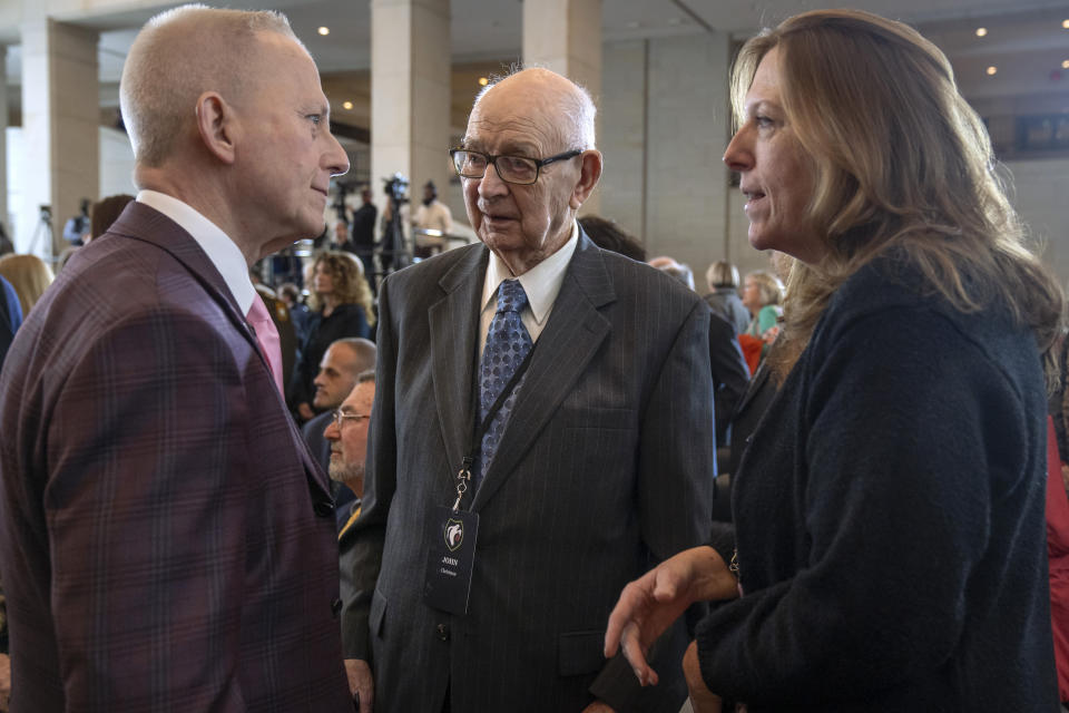 Ghost Army member John Christman, of Leesburg, N.J., center, talks with well-wishers after a ceremony to honor members of their secretive WWII-era unit with the Congressional Gold Medal on Capitol Hill, Thursday, March 21, 2024, in Washington. (AP Photo/Mark Schiefelbein)