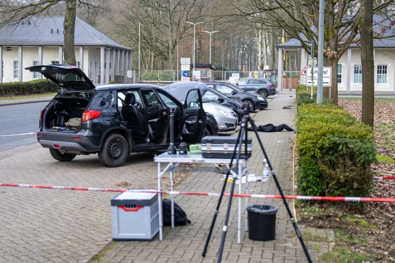 A car is parked behind a cordon near a barracks. A German Bundeswehr soldier is suspected of shooting dead four people in the Lower Saxony district of Rotenburg, before turning himself in, the police and prosecution announced on Friday. Sina Schuldt/dpa