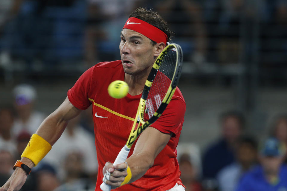 CAPTION CORRECTS SPELLING TO SURNAME Rafael Nadal of Spain plays a shot against Novak Djokovic of Serbia during their ATP Cup tennis match in Sydney, Sunday, Jan. 12, 2020. (AP Photo/Steve Christo)