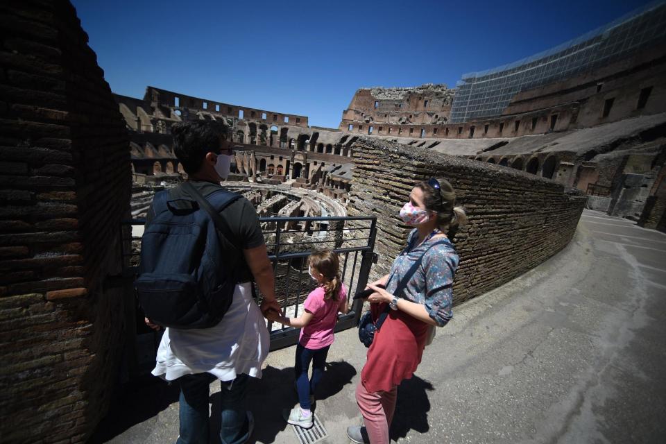 Visitors view the Colosseum monument in Rome (AFP via Getty Images)