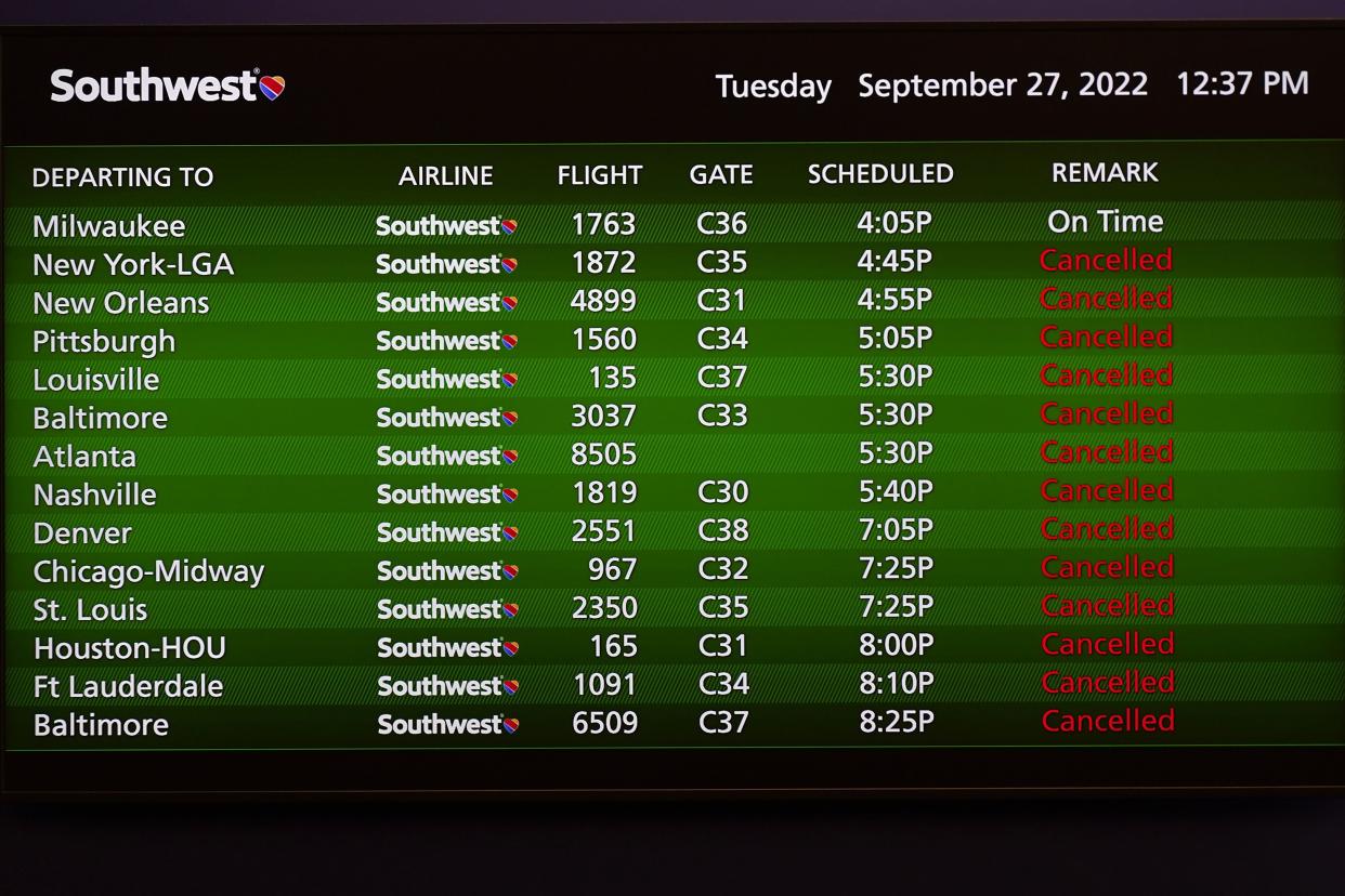 A Southwest Airlines video board at Tampa International Airport shows Tuesday's canceled flights.