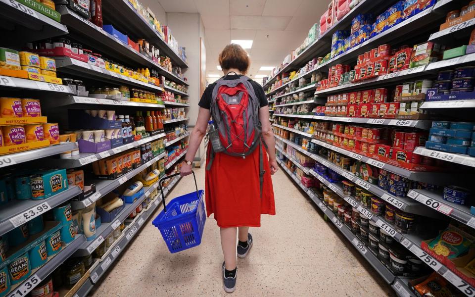 woman walking down supermarket aisles