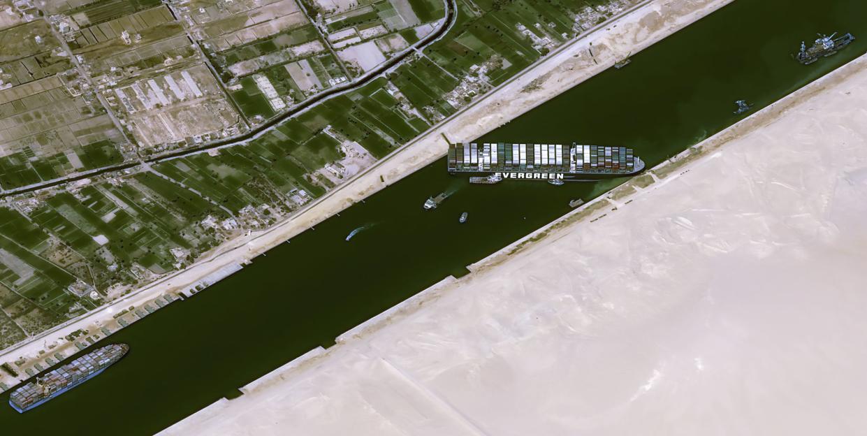 This satellite image from Cnes2021, Distribution Airbus DS, shows the cargo ship MV Ever Given stuck in the Suez Canal near Suez, Egypt, Thursday, March 25, 2021. The skyscraper-sized cargo ship wedged across Egypt's Suez Canal further imperiled global shipping Thursday as at least 150 other vessels needing to pass through the crucial waterway idled waiting for the obstruction to clear, authorities said.