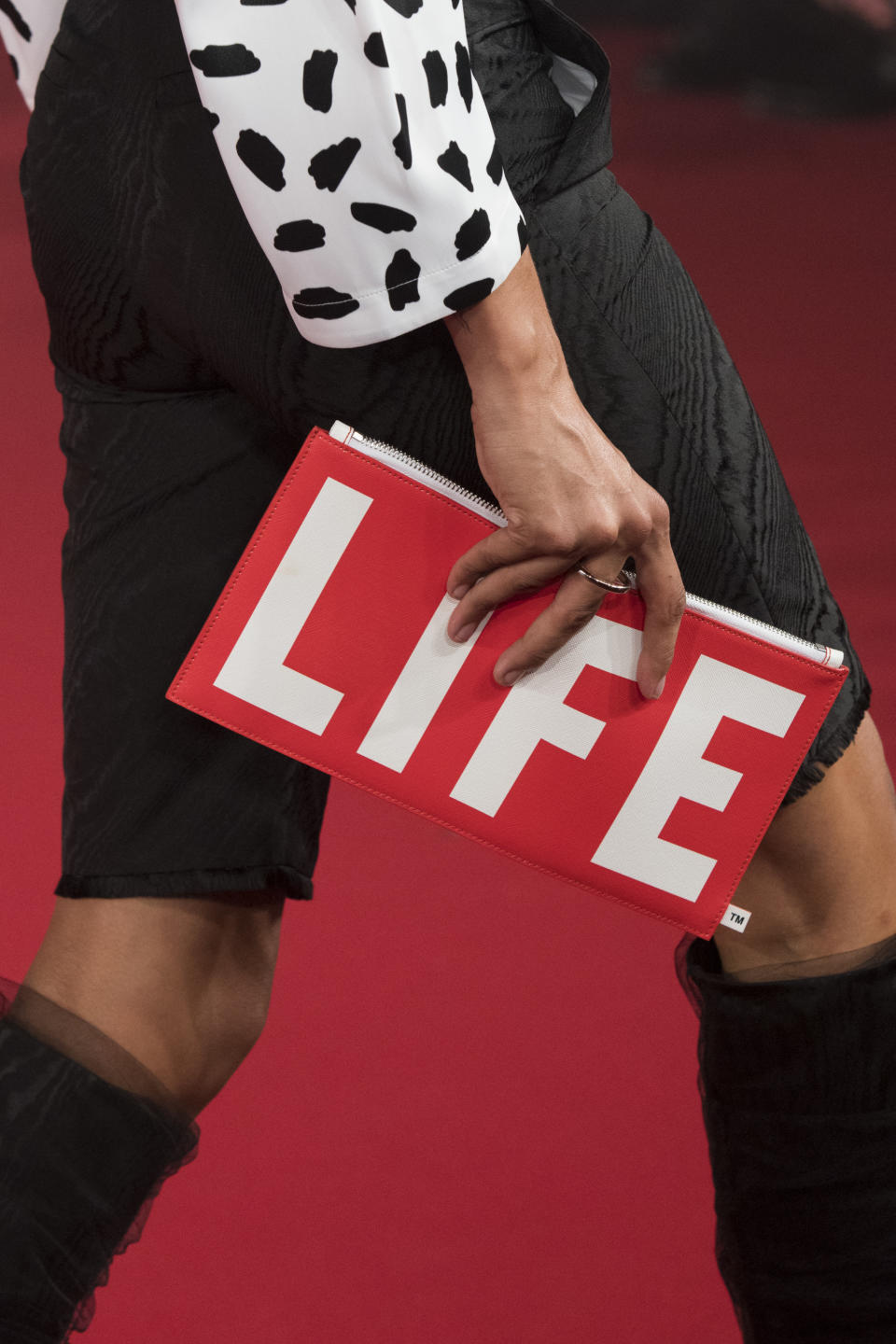 <p><i>‘Life’ branded clutch from the SS18 Off-White collection. (Photo: ImaxTree) </i></p>