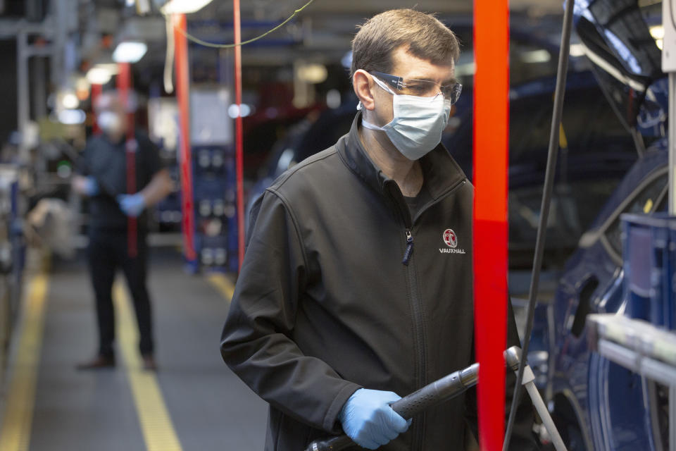 Members of staff working between two-metre wide designated work stations on a car assembly line at the Vauxhall car factory during preparedness tests and redesign ahead of re-opening following the COVID-19 outbreak. Located in Ellesmere Port, Wirral, the factory opened in 1962 and currently employs around 1100 workers. It ceased production on 17 March 2020 and will only resume work upon the advice of the UK Government, which will involve stringent physical distancing measures being in place across the site. (Photo by Colin McPherson/Corbis via Getty Images)