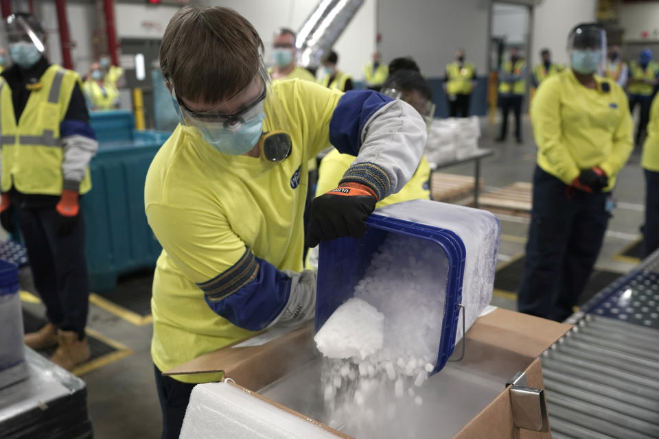 FILE - In this Dec. 13, 2020, file photo, dry ice is poured into a box containing the Pfizer COVID-19 vaccine as it is prepared to be shipped at the Pfizer Global Supply Kalamazoo manufacturing plant in Portage, Mich. The Biden administration plans to provide 500 million shots purchased from Pfizer to 92 lower income countries and the African Union over the next year through the U.N.-backed COVAX program. (AP Photo/Morry Gash, Pool, File)