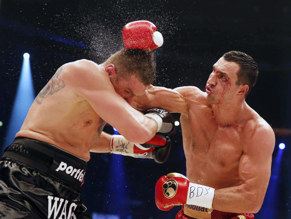 Ukrainian WBA, WBO, IBO and IBF heavy weight boxing world champion Vladimir Klitschko lands a blow on Polish challenger Mariusz Wach during their title bout in Hamburg